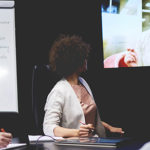 Business people communicating by television set Business people communicating by television set